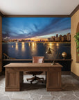Embers On The Horizon wallpaper featuring twilight cityscape with golden reflections on water in home office setting