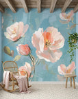 First Blush watercolor floral wallpaper with oversized pink poppies on soft blue background in sunlit room