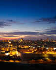 Dramatic First Light wallpaper featuring Jerusalem skyline at dusk with golden city lights and blue sunset sky