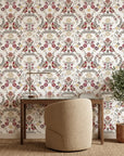 Burgundy and gold Folk Garden peel and stick wallpaper with symmetrical birds and floral motifs in home office