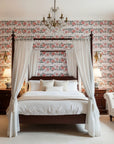 Folk Rose Stitch red and black folk rose wallpaper adding character to a cozy bedroom