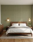 Forest Ledger sage green stripe wallpaper adding character to a cozy bedroom