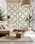 Removable wallpaper featuring a black and cream geometric abstract design of segmented, curved lines (Fragmented Orbit)