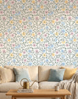 Garden Reverie removable wallpaper with pastel floral vines on cream background in cozy living room
