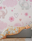 Whimsical baby room wall covering featuring rosy pachyderms and heart-style cloud motifs - Gentle Flutter
