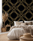 Self-adhesive wallpaper featuring a black and gold geometric diamond trellis pattern (Gilded Cage)