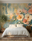 Gilded Garden wallpaper with oversized peach and pink flowers on distressed teal and gold backdrop in cozy bedroom