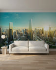 Modern city skyline Glass & Gold mural wallpaper behind living room sofa with turquoise sky