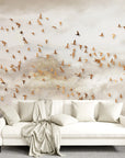 Golden Birds wallpaper with bronze flock in misty clouds on modern living room wall