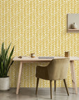 Golden Coral mustard geometric peel and stick wallpaper as a feature wall in a bright home office