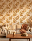 Golden Fern botanical wallpaper with warm tan leaf motifs on textured beige living room accent wall