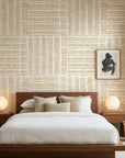 Textured woven grasscloth wallpaper in natural beige tones behind mid-century modern bedroom