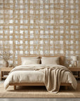 Linen textured Golden Loom wallpaper with distressed gold and cream plaid pattern on bedroom accent wall