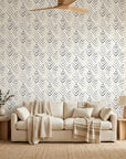 Grey Fret chevron wallpaper on living room accent wall with neutral sofa and textured decor