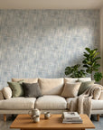 Blue-gray textured Harbour Weave wallpaper on modern living room accent wall with natural light