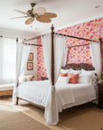 Hibiscus Carnival vibrant pink tropical wallpaper adding character to a cozy bedroom