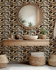 Self-adhesive wallpaper featuring an abstract design of black, white, and metallic gold marble patterning, called Honeyed Strata