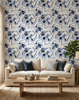 Indigo Anemone bold blue botanical floral wallpaper in a warm and inviting living room