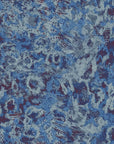 Peel and stick Indigo Static wallpaper featuring a heavily textured blue and purple abstract grunge design