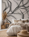 Abstract wall covering featuring running streams of black and beige pigment