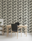 Ink Thicket bold black botanical wallpaper as a feature wall in a bright home office