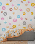 Removable wallpaper featuring a bright spectrum of whimsical animal footprints in a seamless pattern - Joyful Jaunts