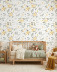 Lemon Grove floral wallpaper with yellow blooms and gray leaves in a serene nursery setting
