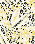 Self-adhesive wall covering decorated with yellow tropical foliage and an integrated leopard spot design