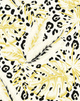 Self-adhesive wall covering decorated with yellow tropical foliage and an integrated leopard spot design