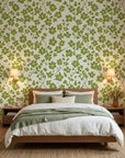 Green and cream Lime Bloom botanical wallpaper featuring clover motifs on modern bedroom accent wall