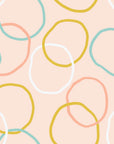 Peel and stick wallpaper featuring an abstract design in pastel pink and yellow, named Loop Dreams