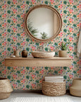 A vibrant, peachy tropical wallpaper pattern adorned with parrots, palm fronds, and striking hibiscus blooms, by Lush Notion