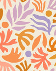 Playful abstract botanical wallpaper with hand painted leaf and floral shapes in peach, lavender, ochre, and soft coral on a warm cream background.