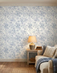 Blue and white Midnight Bloom Drift peel and stick wallpaper in cozy bedroom with natural lighting