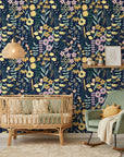 Textured navy Midnight Bouquet wallpaper with yellow, pink, and green wildflowers in modern nursery setting