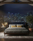 Midnight Constellation cityscape wallpaper on bedroom accent wall showing illuminated buildings against twilight sky