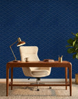 Midnight Crossing bold navy and gold geometric wallpaper adding character to a cozy bedroom