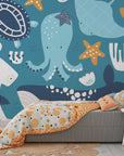 Removable wall covering displaying deep-sea life including cyan whales and octopuses in an oceanic pattern. - Ocean Dreams