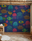 Playful blue wall covering patterned with vibrant, cutout-alike ocean animals