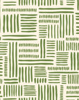 A warm cream background supports an abstract, hand-painted wallpaper pattern featuring loose blocks of olive green brush strokes configured in a geometric alignment