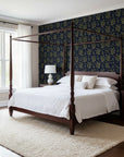 Olive & Gilt elegant navy botanical wallpaper adding character to a cozy bedroom