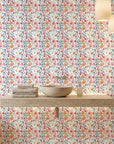 Painted Blooms pastel floral peel and stick wallpaper creating ambiance in a serene bathroom
