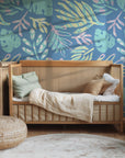 Pastel-toned tropical palm fronds rendered in a chalk-effect style on a calming blue wallpaper