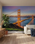 Golden Gate Bridge at sunset mural wallpaper on living room accent wall with purple and orange sky