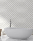 Beige and cream Pastel Bouquet Parade peel and stick wallpaper in minimalist spa bathroom with freestanding tub
