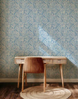 This blue geometric wallpaper uses hand-painted watercolor shapes in a porcelain style to construct a repeating diamond lattice pattern atop a white base