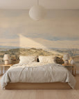Riverside Landscape mural wallpaper featuring golden hills and cloudy sky in serene bedroom setting