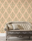 Peach and gold Rosewater Retreat damask wallpaper behind tufted vintage sofa in elegant living room