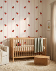 Ruby Streams ladybug stripe wallpaper in a warm and inviting living room