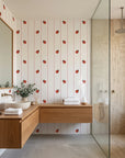 Ruby Streams ladybug stripe wallpaper creating ambiance in a serene bathroom